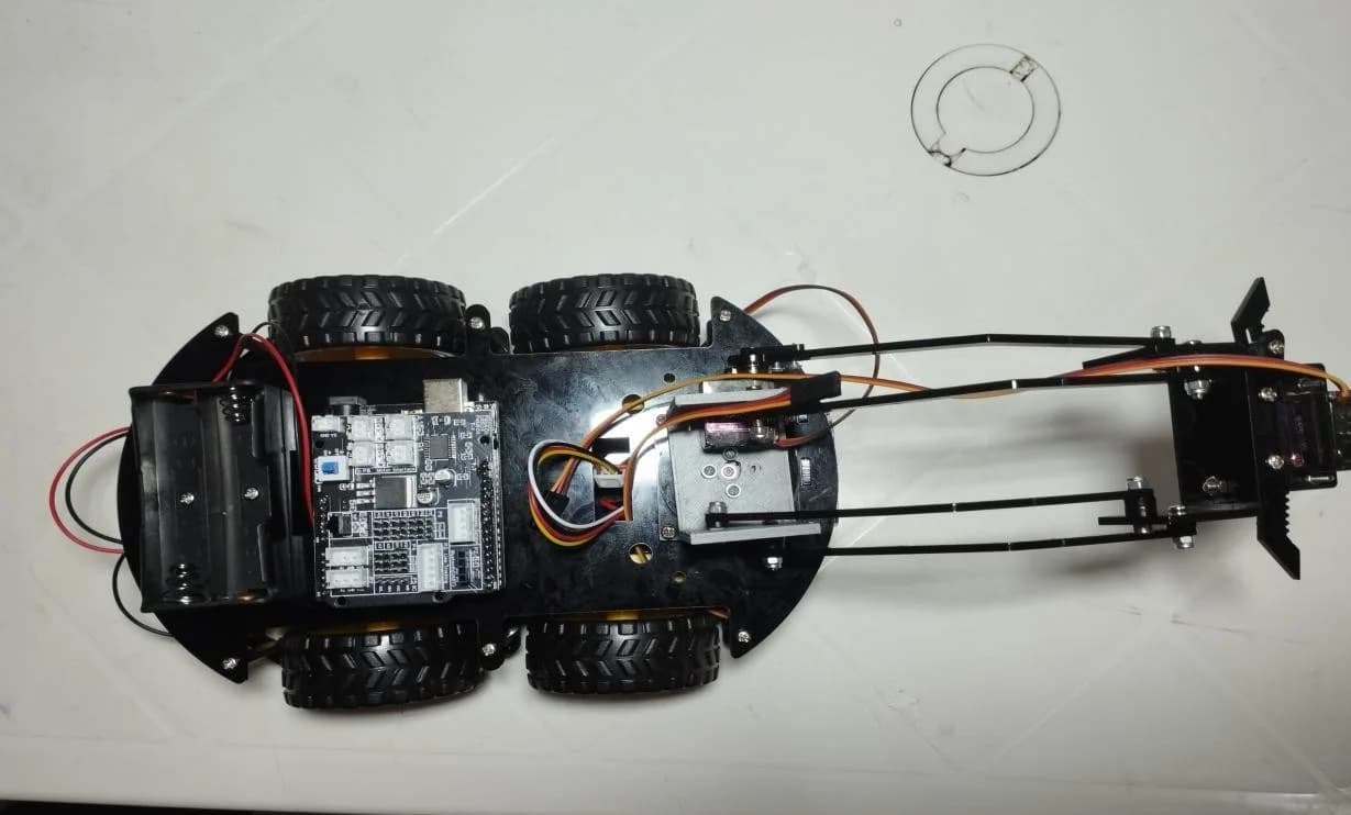 CoffeeBot from above, showing the boards, battery and arm