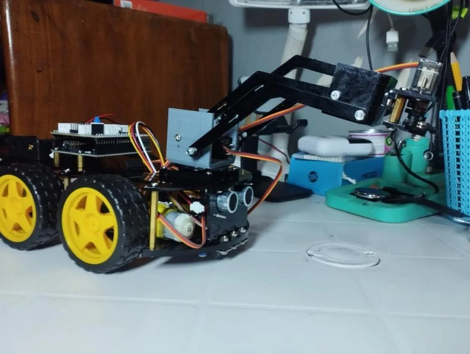 The finished CoffeeBot on a table, arm raised