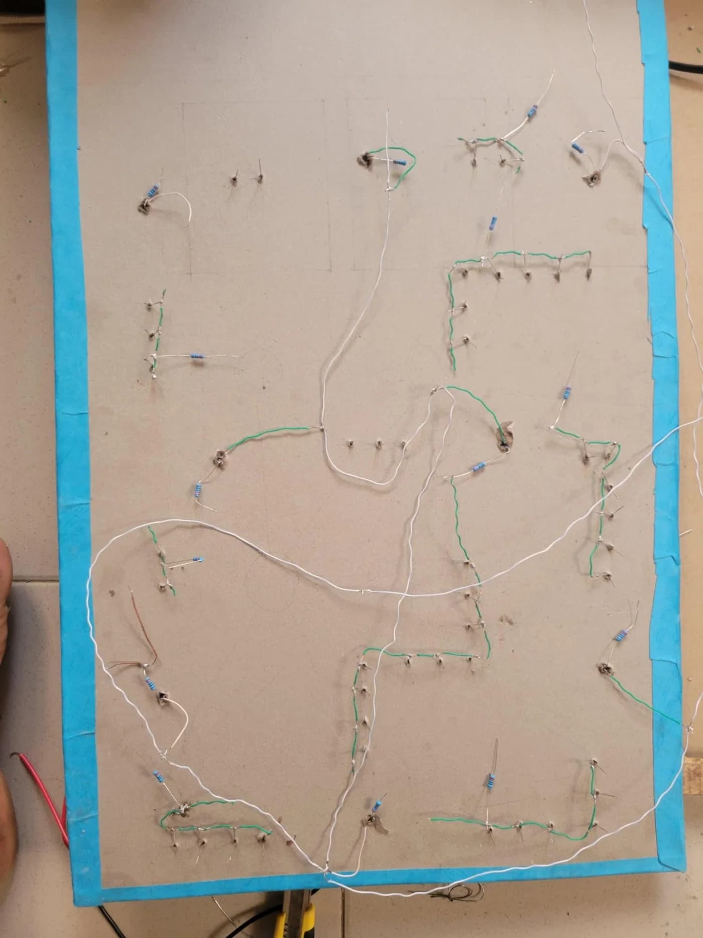 The back of the board showing LED legs, green jumpers, resistors and white bus wires